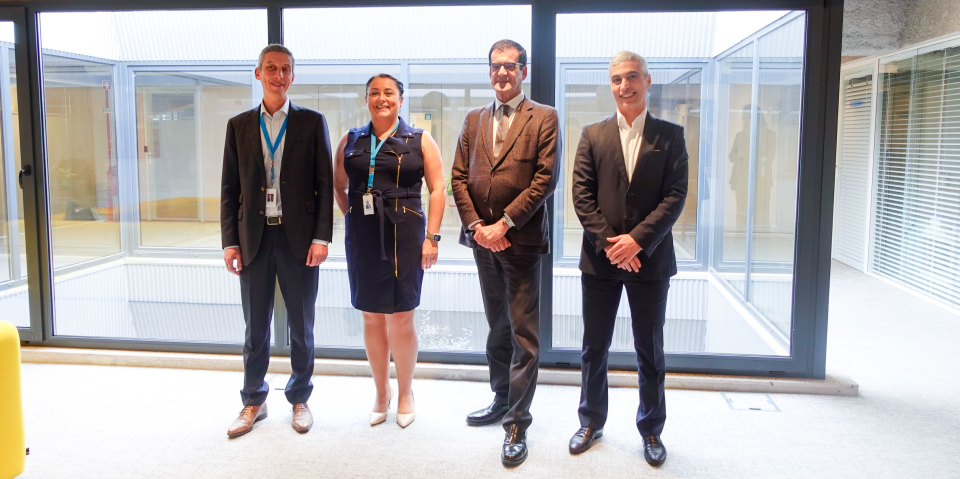 Four people standing in an office
